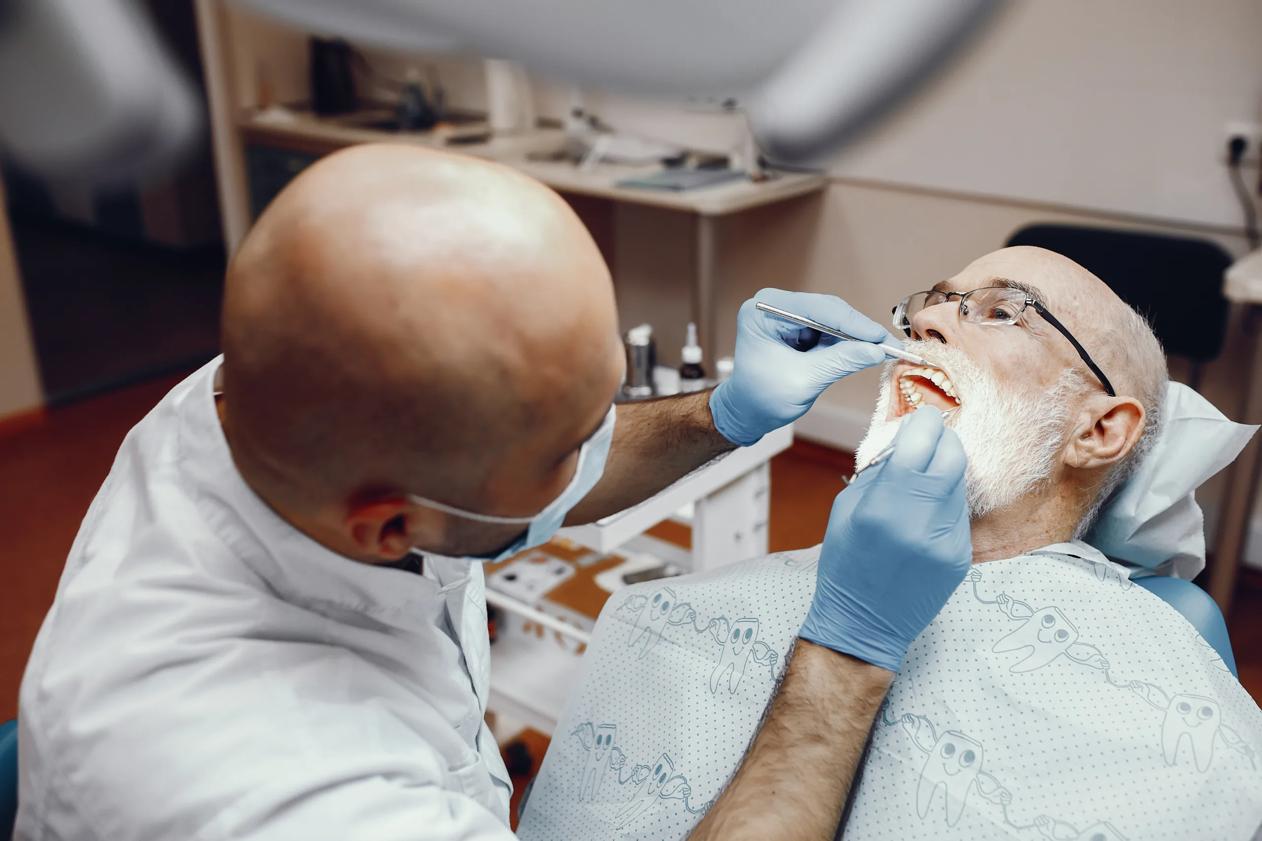 old man talking to the dentist